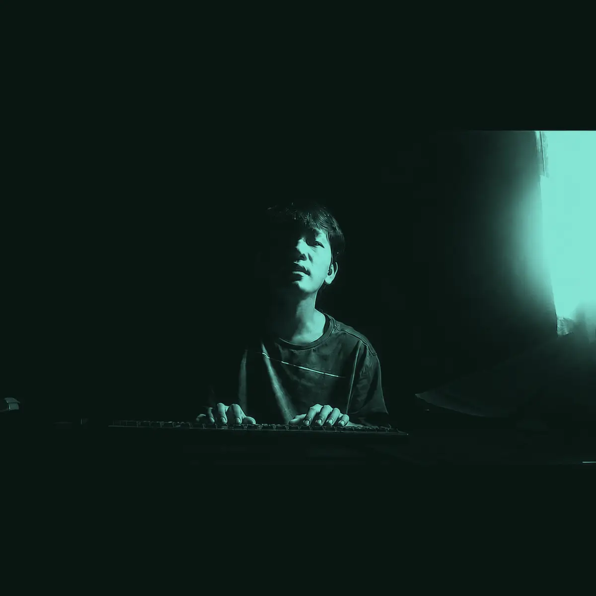 A dark keyboard workspace where Aekkarat writes and tests code off-shift
